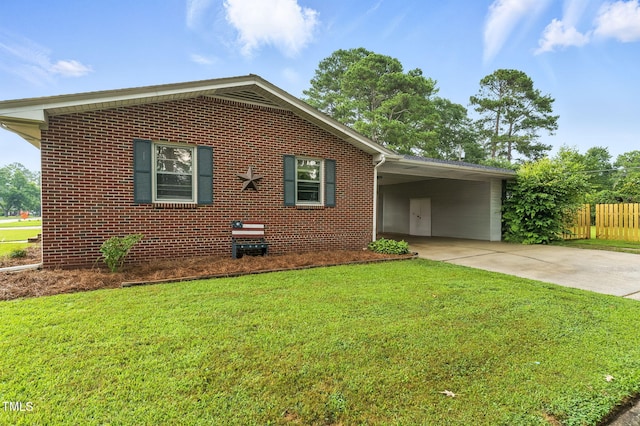 1015 S 1st St, Smithfield, NC 27577 - view of side of home with driveway, brick siding, and a carport