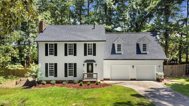 1609 Falls Ct, Raleigh, NC 27615 - view of front of house with concrete driveway, roof with shingles, a chimney, and a garage