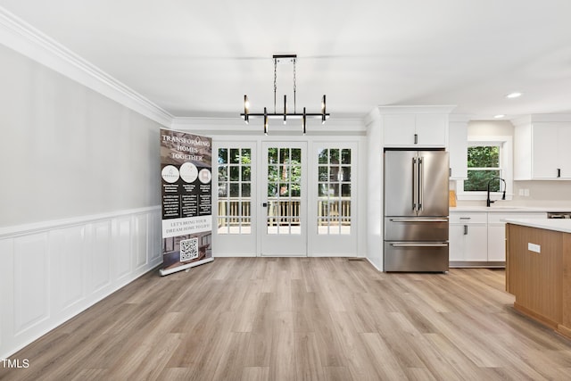 1609 Falls Ct, Raleigh, NC 27615 - unfurnished dining area featuring crown molding, light wood finished floors, a chandelier, recessed lighting, and a wainscoted wall