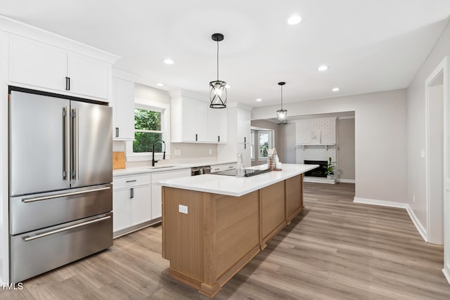 1609 Falls Ct, Raleigh, NC 27615 - kitchen with high quality fridge, black electric stovetop, light countertops, white cabinetry, and recessed lighting