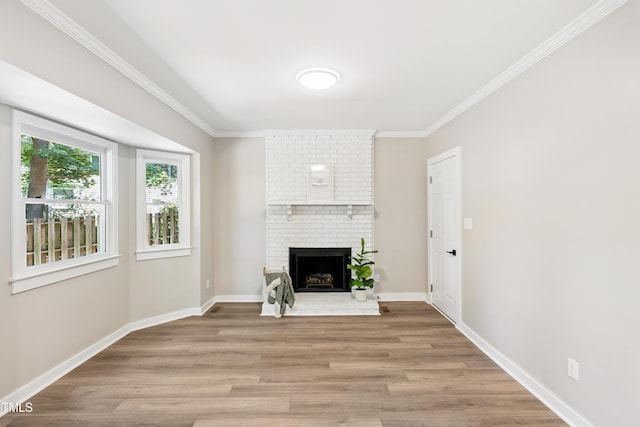 1609 Falls Ct, Raleigh, NC 27615 - unfurnished living room featuring light wood-style flooring, crown molding, and a fireplace