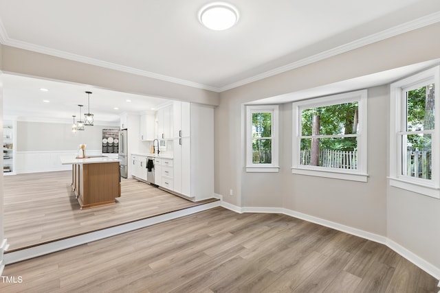 1609 Falls Ct, Raleigh, NC 27615 - kitchen featuring stainless steel refrigerator, light wood-style floors, light countertops, white cabinetry, and a center island with sink