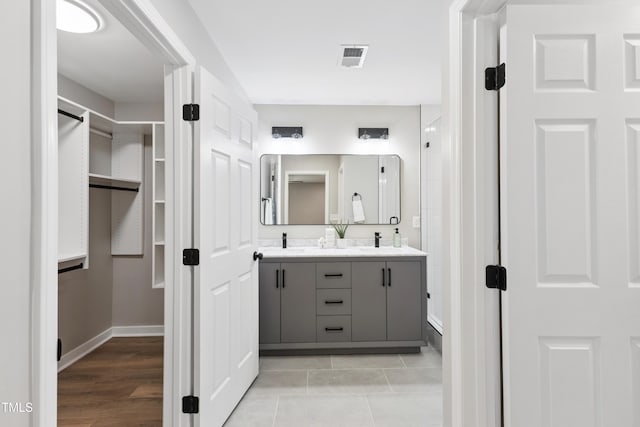 1609 Falls Ct, Raleigh, NC 27615 - full bathroom with double vanity, a walk in closet, and a shower