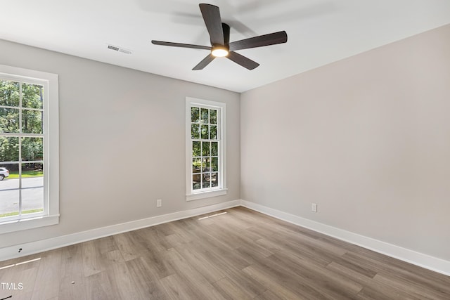 1609 Falls Ct, Raleigh, NC 27615 - empty room featuring light wood-style flooring and plenty of natural light