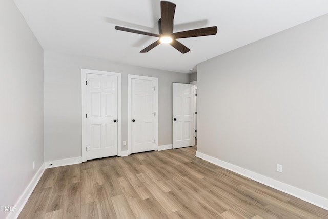 1609 Falls Ct, Raleigh, NC 27615 - unfurnished bedroom with two closets, light wood finished floors, and ceiling fan
