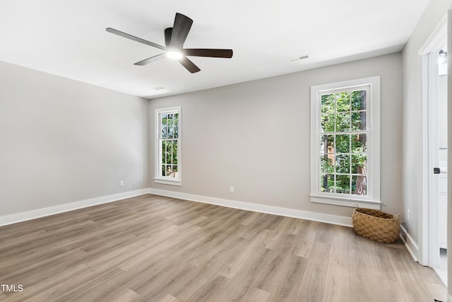 1609 Falls Ct, Raleigh, NC 27615 - empty room featuring a ceiling fan, light wood finished floors, and plenty of natural light