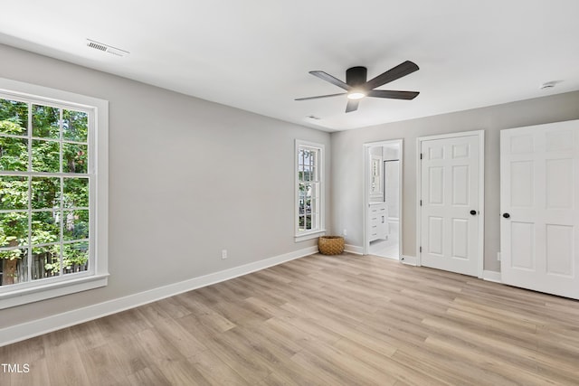 1609 Falls Ct, Raleigh, NC 27615 - unfurnished bedroom with light wood finished floors, multiple windows, and ensuite bathroom