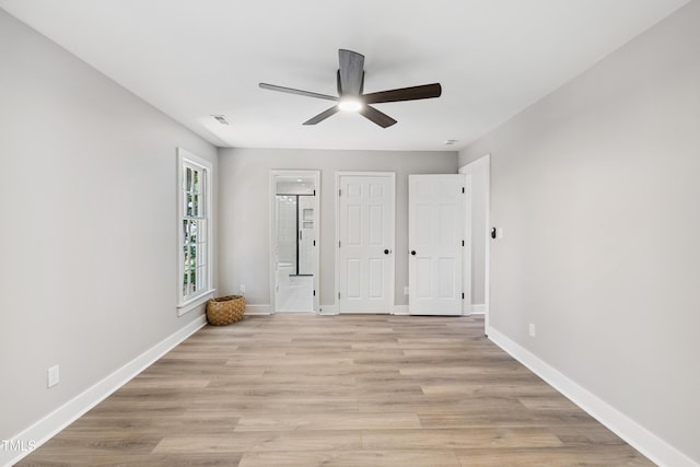 1609 Falls Ct, Raleigh, NC 27615 - unfurnished bedroom with ensuite bathroom, light wood-style flooring, and a ceiling fan