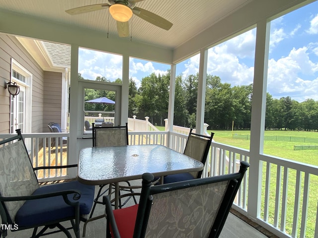 3011 Elk Rdg, Hurdle Mills, NC 27541 - sunroom featuring ceiling fan, outdoor dining space, and view of scattered trees