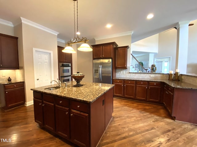 3011 Elk Rdg, Hurdle Mills, NC 27541 - kitchen with appliances with stainless steel finishes, crown molding, backsplash, an island with sink, and stone counters