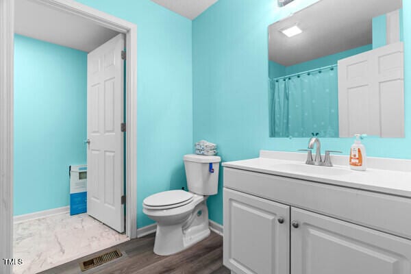 509 S Mckay Ave, Dunn, NC 28334 - bathroom featuring vanity and wood finished floors
