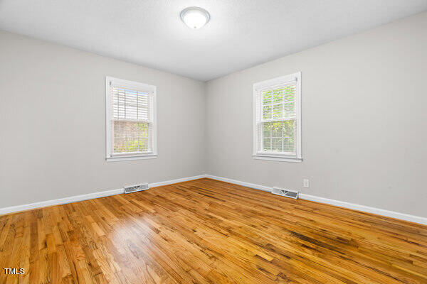 509 S Mckay Ave, Dunn, NC 28334 - empty room with light wood-type flooring and baseboards