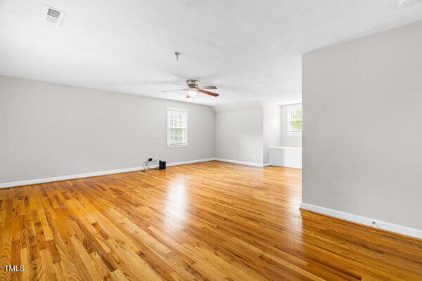 509 S Mckay Ave, Dunn, NC 28334 - unfurnished room featuring healthy amount of natural light, ceiling fan, and light wood-style floors