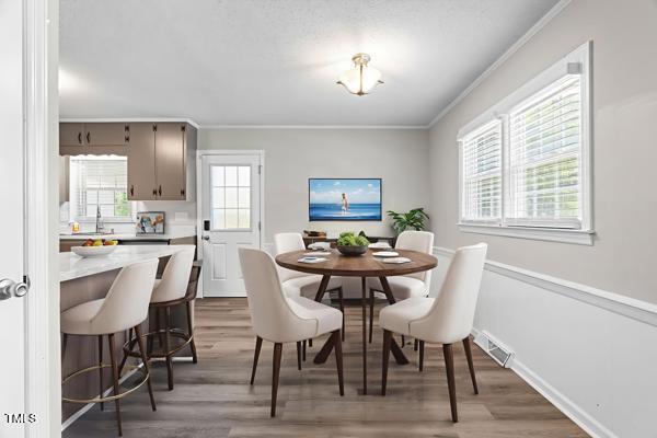 509 S Mckay Ave, Dunn, NC 28334 - dining room with crown molding and wood finished floors