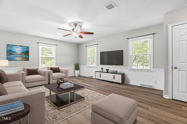 509 S Mckay Ave, Dunn, NC 28334 - living room featuring healthy amount of natural light, wood finished floors, and ceiling fan