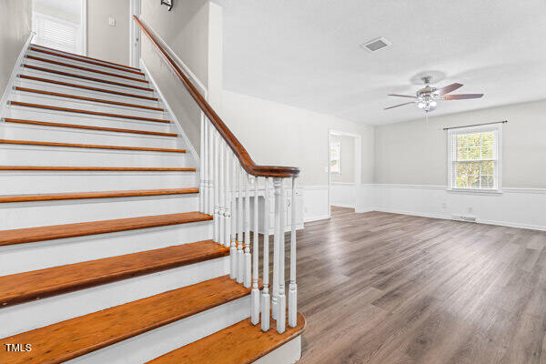 509 S Mckay Ave, Dunn, NC 28334 - stairs featuring a ceiling fan and wood finished floors