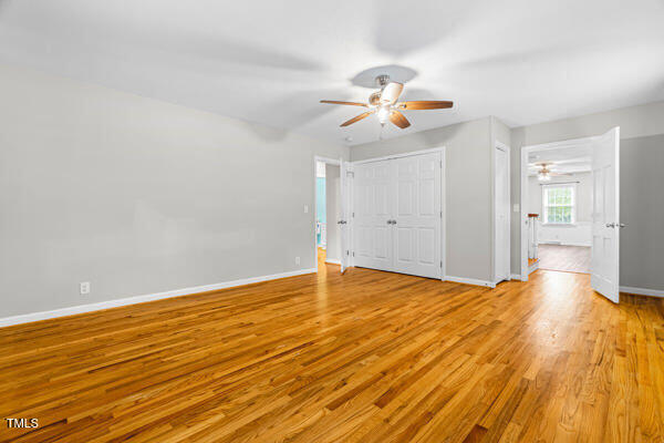 509 S Mckay Ave, Dunn, NC 28334 - unfurnished bedroom featuring wood finished floors and ceiling fan
