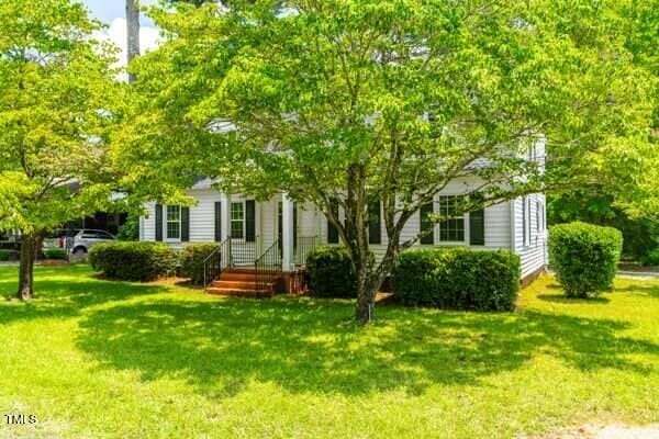 509 S Mckay Ave, Dunn, NC 28334 - view of property hidden behind natural elements featuring a front yard