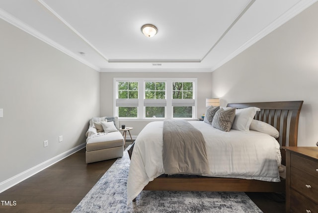 1125 Surveyor Dr, Durham, NC 27703 - bedroom featuring a tray ceiling, dark wood finished floors, and ornamental molding