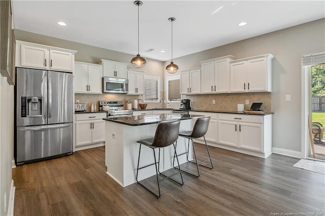 123 Sorrel Ct, Raeford, NC 28376 - kitchen featuring appliances with stainless steel finishes, dark countertops, dark wood finished floors, white cabinets, and recessed lighting