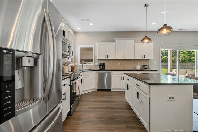 123 Sorrel Ct, Raeford, NC 28376 - kitchen featuring stainless steel appliances, recessed lighting, backsplash, a center island, and dark wood-type flooring