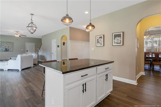 123 Sorrel Ct, Raeford, NC 28376 - kitchen with arched walkways, a chandelier, dark wood finished floors, and recessed lighting