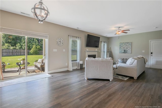 123 Sorrel Ct, Raeford, NC 28376 - living room featuring dark wood-style flooring, a chandelier, ceiling fan, and a fireplace