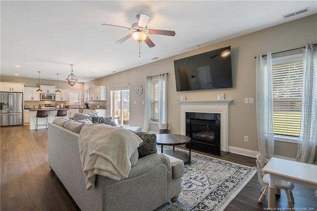 123 Sorrel Ct, Raeford, NC 28376 - living room with a ceiling fan, dark wood-style flooring, recessed lighting, and a glass covered fireplace
