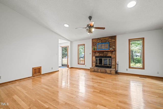 601 Wofford Rd, Durham, NC 27707 - unfurnished living room featuring a textured ceiling, light wood finished floors, a ceiling fan, a fireplace, and recessed lighting