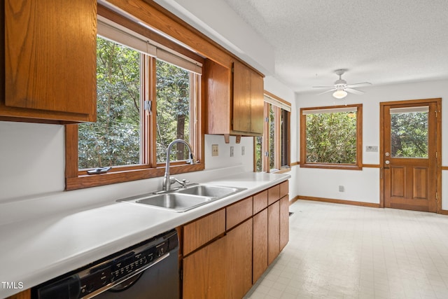 601 Wofford Rd, Durham, NC 27707 - kitchen featuring black dishwasher, light countertops, plenty of natural light, and a textured ceiling