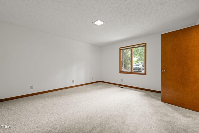 601 Wofford Rd, Durham, NC 27707 - carpeted spare room with a textured ceiling and baseboards