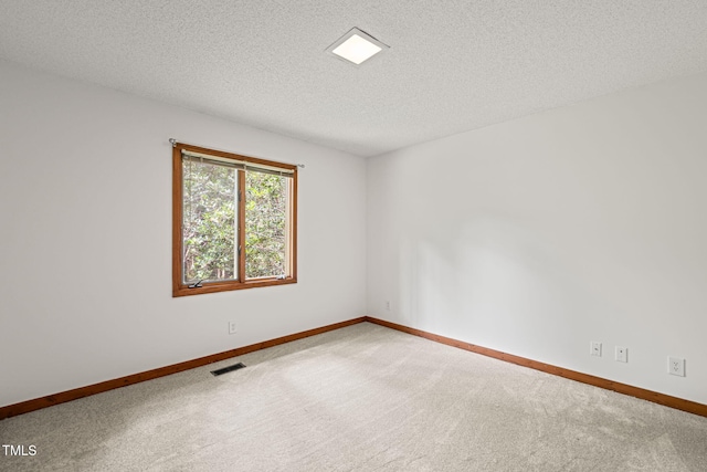 601 Wofford Rd, Durham, NC 27707 - carpeted spare room with baseboards and a textured ceiling