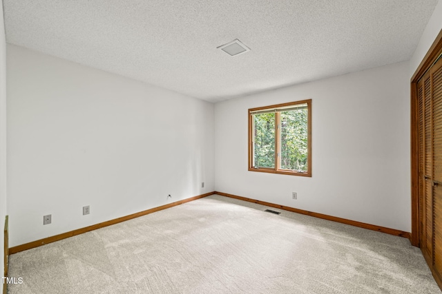 601 Wofford Rd, Durham, NC 27707 - unfurnished bedroom featuring carpet, a textured ceiling, and a closet