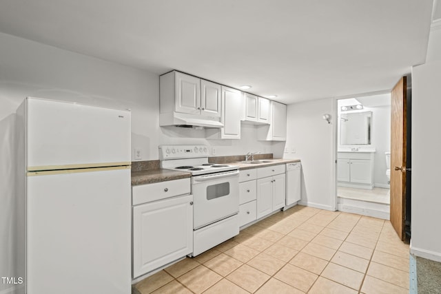 601 Wofford Rd, Durham, NC 27707 - kitchen with white appliances, under cabinet range hood, white cabinetry, light tile patterned flooring, and dark countertops