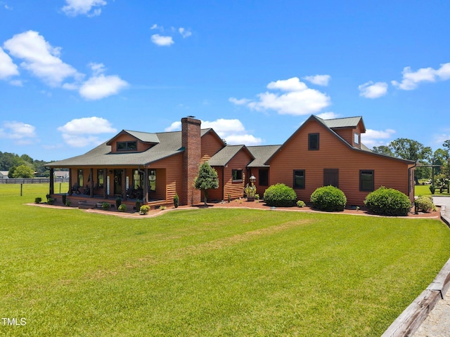 rear view of property featuring covered porch and a chimney