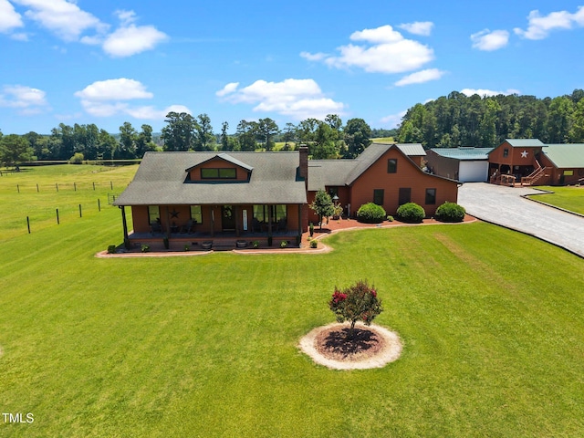 view of front of property featuring covered porch, driveway, and a chimney