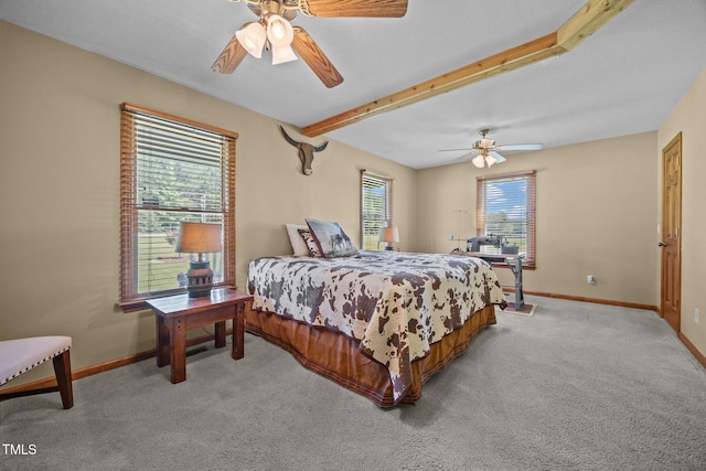 bedroom with carpet floors, beamed ceiling, and ceiling fan