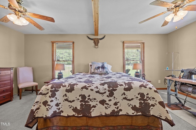 carpeted bedroom featuring a ceiling fan and beam ceiling