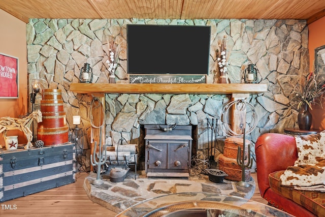 detailed view of wood ceiling, wood finished floors, and a wood stove