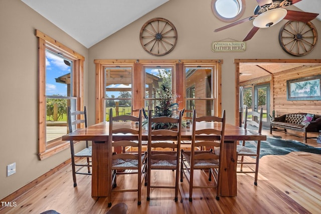 dining room with wood finished floors, vaulted ceiling, and ceiling fan