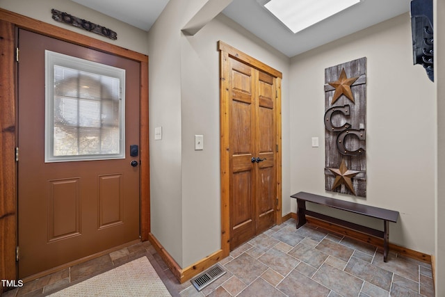 entrance foyer with baseboards and light stone finish flooring