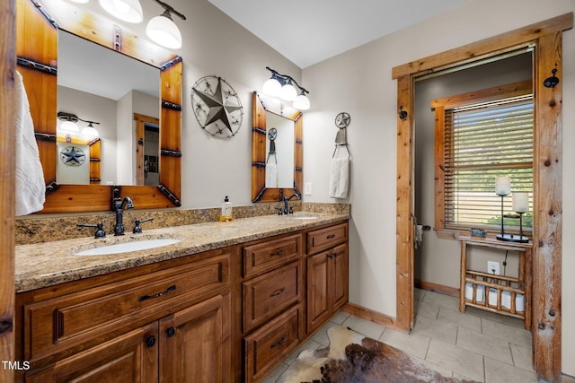 bathroom with double vanity and tile patterned floors