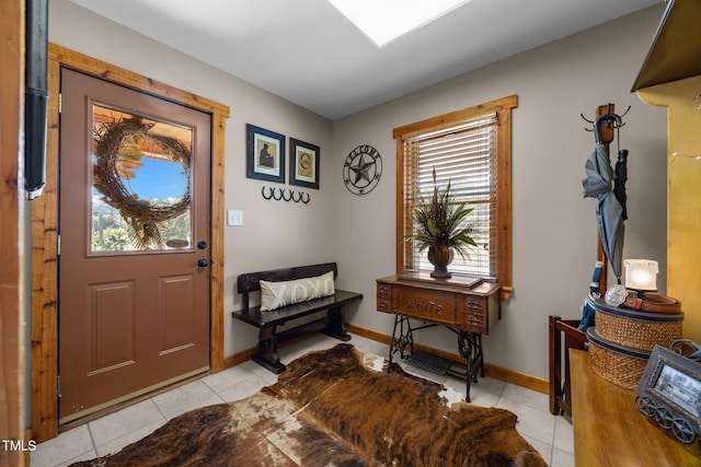 entrance foyer featuring light tile patterned floors and baseboards