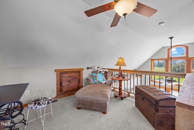 living area with vaulted ceiling, carpet, and a ceiling fan