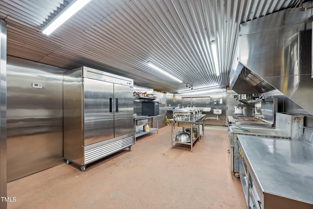 kitchen featuring concrete floors and stainless steel counters
