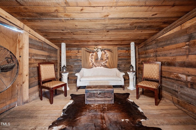 sitting room featuring wood ceiling, vaulted ceiling, wooden walls, and hardwood / wood-style floors