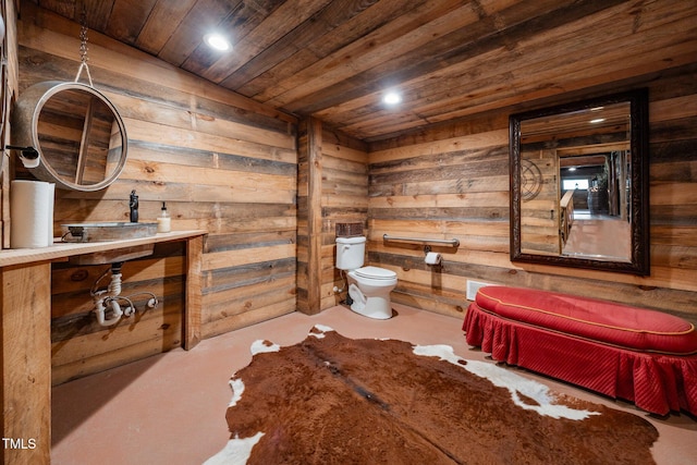 bathroom with wooden walls, wooden ceiling, concrete flooring, and recessed lighting
