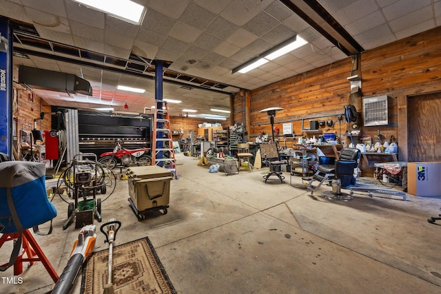 garage with wood walls and a workshop area