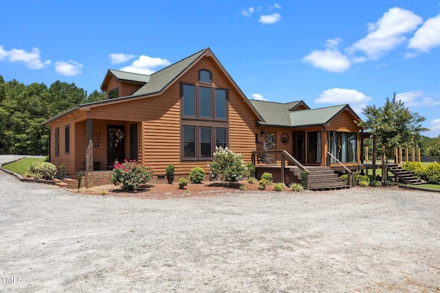 rustic home with a sunroom and a wooden deck