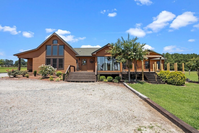 view of front of property featuring a front lawn, stairs, and a wooden deck